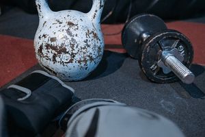 Single kettlebell on a dark floor in a minimalist gym